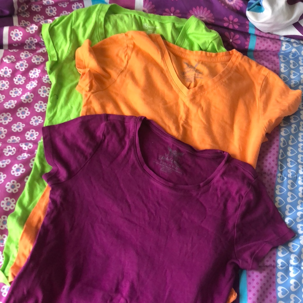 Bundles of shirts orange, green, violet